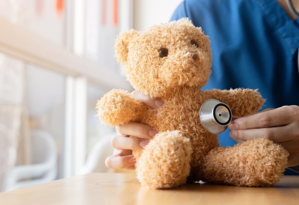 Диспансеризация ребёнка в 2 года: врач осматривает плюшевого мишку стетоскопом — символ полного чек-апа здоровья малыша